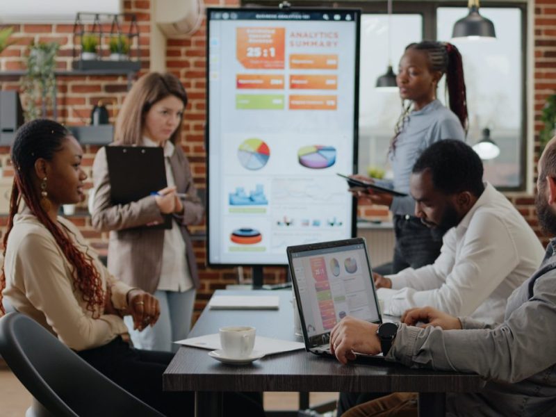 diverse-team-of-people-presenting-business-growth-on-screen.jpg